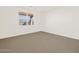 Well-lit bedroom featuring a large window and neutral carpet at 3845 N Camden Dr, Florence, AZ 85132