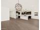 Open-concept kitchen and living area with a kitchen island, stainless steel appliances, and a modern chandelier at 3845 N Camden Dr, Florence, AZ 85132