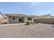 Nice backyard showcasing a garden area, rock landscaping and privacy wall at 41279 W Elm Dr, Maricopa, AZ 85138