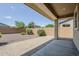 Private backyard with landscaped stone, covered patio, and block wall at 41279 W Elm Dr, Maricopa, AZ 85138