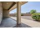 Relaxing covered patio with a view of the gravel and shrubbery backyard at 41279 W Elm Dr, Maricopa, AZ 85138