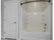 Bathroom featuring a white tub and shower combo with tiled walls at 41279 W Elm Dr, Maricopa, AZ 85138