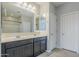 Bathroom featuring double sinks, a large mirror, and a shower-tub combo at 41279 W Elm Dr, Maricopa, AZ 85138