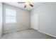 Bright carpeted bedroom with a window and a closet at 41279 W Elm Dr, Maricopa, AZ 85138