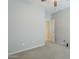 Carpeted bedroom with an entrance to a hallway at 41279 W Elm Dr, Maricopa, AZ 85138