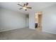 Spacious bedroom featuring a ceiling fan and an ensuite bathroom entrance at 41279 W Elm Dr, Maricopa, AZ 85138