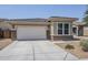 Charming single-story home featuring a two-car garage and low maintenance desert landscaping at 41279 W Elm Dr, Maricopa, AZ 85138