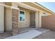 Front entrance featuring a secure screen door and desert landscaping at 41279 W Elm Dr, Maricopa, AZ 85138