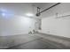 Clean, empty garage with ample space for vehicles and storage at 41279 W Elm Dr, Maricopa, AZ 85138