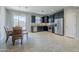 Well-lit kitchen features stainless steel appliances, dark cabinetry, and an adjacent dining area with seating at 41279 W Elm Dr, Maricopa, AZ 85138