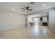 Open-concept living room with dining area, kitchen, tile flooring and ceiling fan at 41279 W Elm Dr, Maricopa, AZ 85138