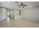 Open-concept living room with tile flooring, ceiling fan and neutral paint at 41279 W Elm Dr, Maricopa, AZ 85138
