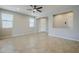 Open-concept living room with tile flooring, ceiling fan and neutral paint at 41279 W Elm Dr, Maricopa, AZ 85138