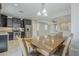 Open living space showcases a kitchen with stainless steel appliances, dark cabinetry and large dining table at 41279 W Elm Dr, Maricopa, AZ 85138