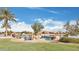 Beautiful lake view with waterfall feature and lush green grass near the houses in a well maintained community at 41279 W Elm Dr, Maricopa, AZ 85138