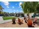 Spacious backyard with lush lawn, patio, outdoor kitchen, and comfortable seating areas at 4136 E Eugie Ave, Phoenix, AZ 85032