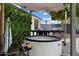 Relaxing backyard with a hot tub, lush vertical garden, and grill area at 4136 E Eugie Ave, Phoenix, AZ 85032