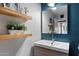 Stylish bathroom featuring floating shelves, modern vanity, and shiplap accent wall at 4136 E Eugie Ave, Phoenix, AZ 85032