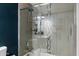 Bright bathroom showcasing a tiled shower with glass door and decorative vertical accent at 4136 E Eugie Ave, Phoenix, AZ 85032