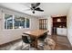 Dining room with wood table, modern chairs, and mini bar, all complimented by a large window overlooking outdoor patio at 4136 E Eugie Ave, Phoenix, AZ 85032