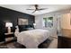 Comfortable bedroom with stylish ceiling fan and a large window view at 4136 E Eugie Ave, Phoenix, AZ 85032
