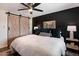 Comfortable main bedroom with a barn door, accent wall, and lots of pillows for a relaxing night's sleep at 4136 E Eugie Ave, Phoenix, AZ 85032
