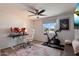 Comfortable office with modern desk and chair, large window, and exercise bike for a perfect work/life balance at 4136 E Eugie Ave, Phoenix, AZ 85032
