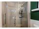 Modern shower with glass door and tile accents, and lots of natural light from the window at 4136 E Eugie Ave, Phoenix, AZ 85032