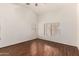 Spacious bedroom with hardwood floors, neutral walls, and plenty of natural light at 42458 W Desert Fairways Dr, Maricopa, AZ 85138