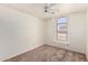 Bright bedroom with a ceiling fan and a large window offering plenty of natural light at 42458 W Desert Fairways Dr, Maricopa, AZ 85138