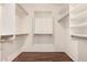 Spacious walk-in closet with ample shelving and hardwood floors at 42458 W Desert Fairways Dr, Maricopa, AZ 85138