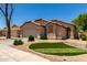 Well-presented one-story house showcasing neat landscaping and an attached two-car garage at 42458 W Desert Fairways Dr, Maricopa, AZ 85138