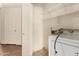 Laundry area with shelving and a washing machine, plus doorway at 42458 W Desert Fairways Dr, Maricopa, AZ 85138