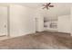Bright and airy living room featuring carpeted floors and an open layout design at 42458 W Desert Fairways Dr, Maricopa, AZ 85138