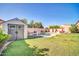 Landscaped backyard with storage shed, waterfall pool, hardscape, and grassy play areas at 4408 W Summerside Rd, Laveen, AZ 85339