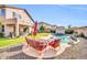 Beautiful backyard featuring a pool, patio with outdoor seating, and a well-maintained lawn at 4408 W Summerside Rd, Laveen, AZ 85339
