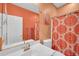 Well-lit bathroom with a single sink vanity, decorative shower curtain, and modern fixtures at 4408 W Summerside Rd, Laveen, AZ 85339