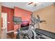 Home exercise room featuring an elliptical machine, treadmill, stationary bike, and flat screen tv at 4408 W Summerside Rd, Laveen, AZ 85339