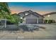 Charming home featuring a three car garage, desert landscaping and grey facade at 4408 W Summerside Rd, Laveen, AZ 85339