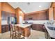 Well-lit kitchen featuring stainless steel appliances, granite countertops, and a central island with seating at 4408 W Summerside Rd, Laveen, AZ 85339