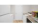 Bright laundry room with washer, dryer, freezer, tile floor and white door at 4408 W Summerside Rd, Laveen, AZ 85339