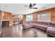 Open concept living area with dark wood floors, large comfortable sofa, and ample natural light at 4408 W Summerside Rd, Laveen, AZ 85339