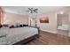 Large bedroom featuring warm colors, wood flooring, a ceiling fan and a TV for relaxed living at 4408 W Summerside Rd, Laveen, AZ 85339