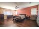 Spacious bedroom boasts stylish furnishings, wood floors, and abundant natural light for a comfortable retreat at 4408 W Summerside Rd, Laveen, AZ 85339