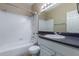 Neutral bathroom with a shower-tub combination, white fixtures, and dark countertop at 4465 E Paradise Village S Pkwy # 1224, Phoenix, AZ 85032