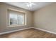Bedroom with a ceiling fan, window with blinds, and sleek wood-look flooring at 4465 E Paradise Village S Pkwy # 1224, Phoenix, AZ 85032