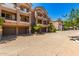 Attractive townhome exteriors feature multiple garages, patios with decorative railings, and lush desert landscaping at 4465 E Paradise Village S Pkwy # 1224, Phoenix, AZ 85032