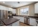 Modern kitchen featuring stainless appliances, solid countertops, and bright white cabinetry at 4465 E Paradise Village S Pkwy # 1224, Phoenix, AZ 85032