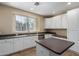 The gorgeous kitchen features stone countertops, sleek stainless appliances, and white cabinetry at 4465 E Paradise Village S Pkwy # 1224, Phoenix, AZ 85032