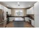 Eat-in kitchen featuring an island, stone countertops, stainless steel appliances, and crisp white cabinetry at 4465 E Paradise Village S Pkwy # 1224, Phoenix, AZ 85032